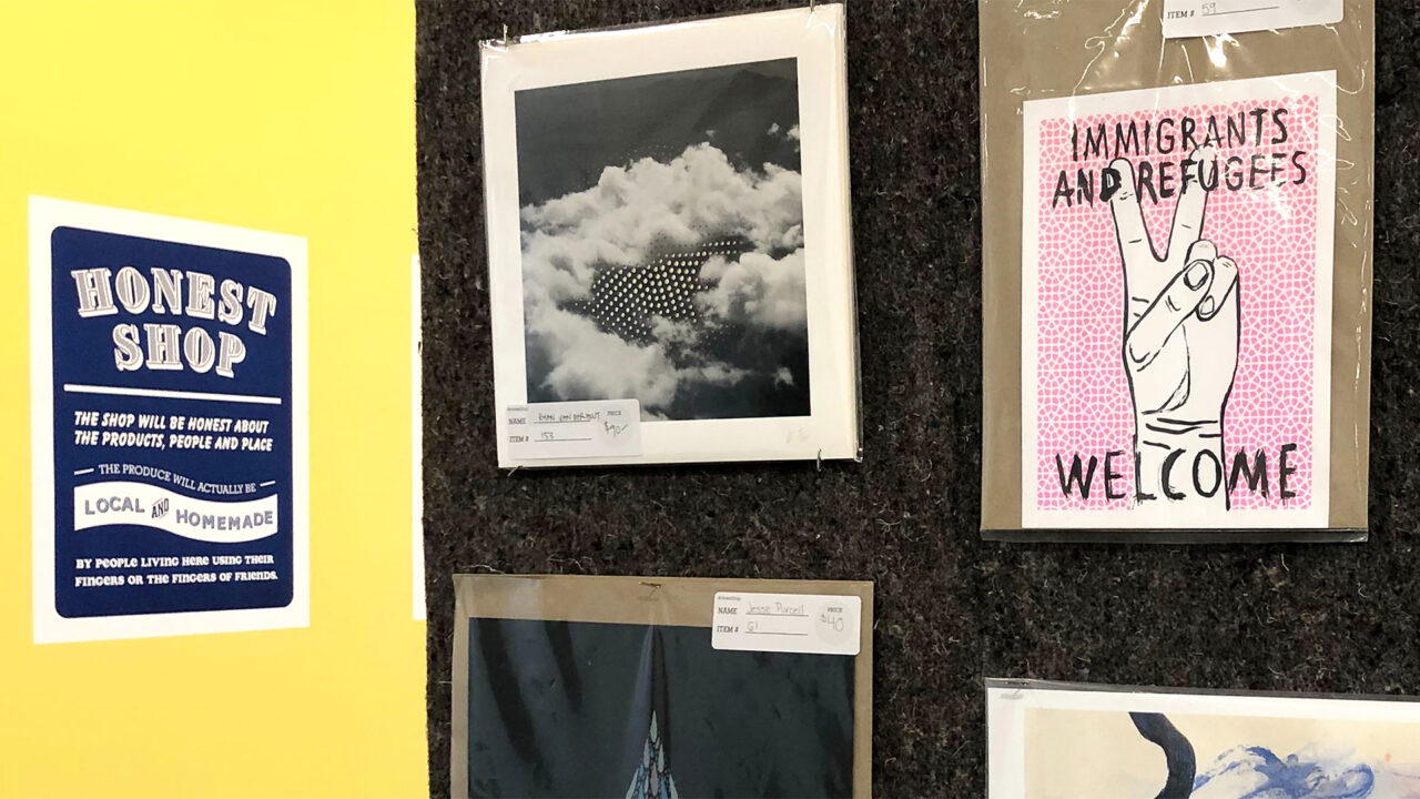 A sign of "Honest Shop" on the left side and a few prints created by local makers